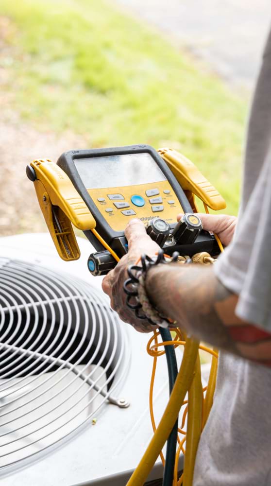 Williams services worker testing HVAC unit